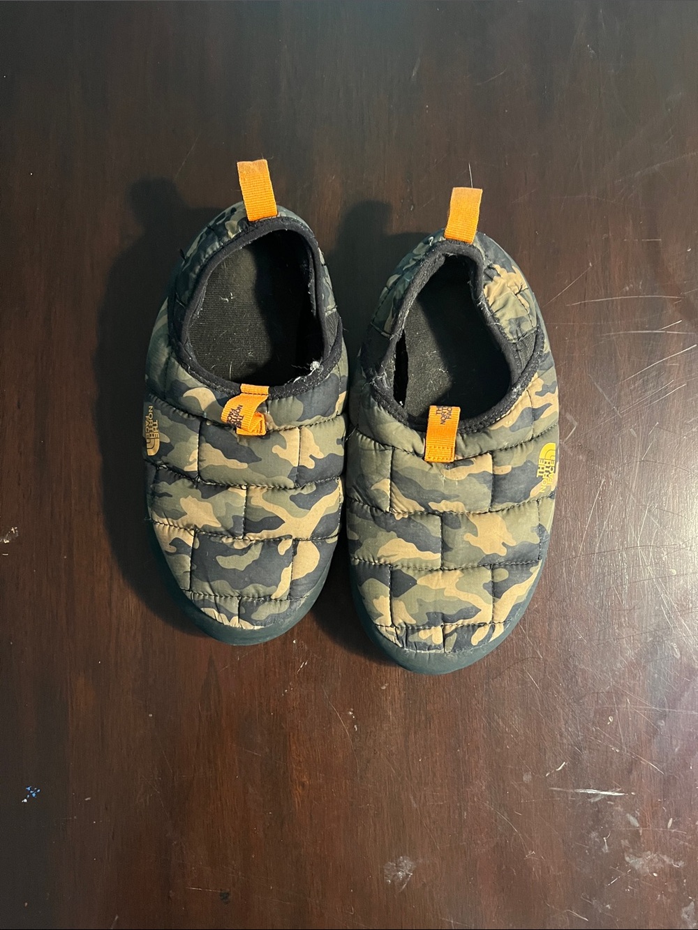 The North Face Kids Camo Quilted Slip-On Shoes with Orange Pull Tabs
